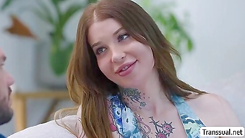 A Shemale and a guy are having anal sex on the bed